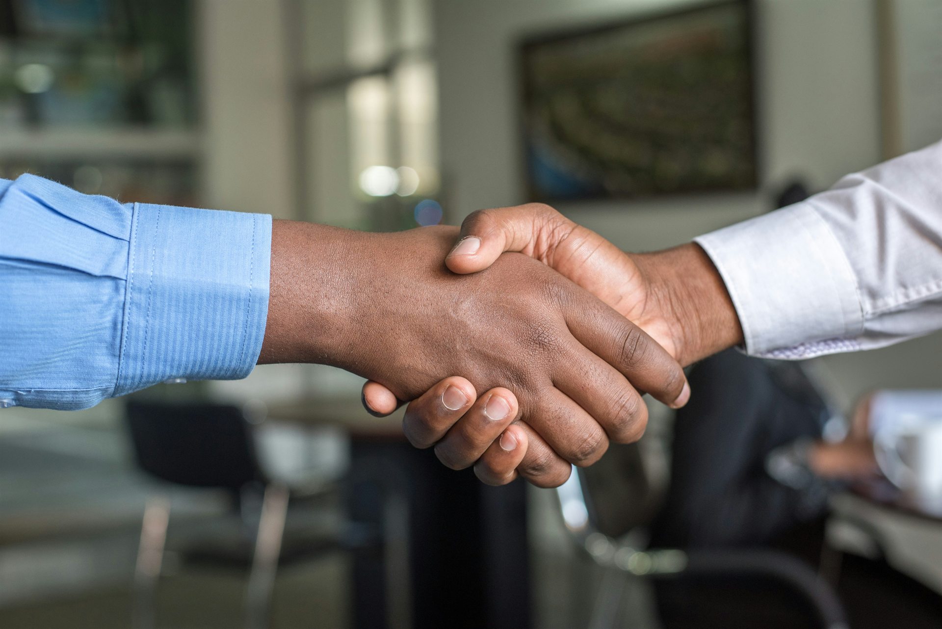 Two people shaking hands to begin a partnership